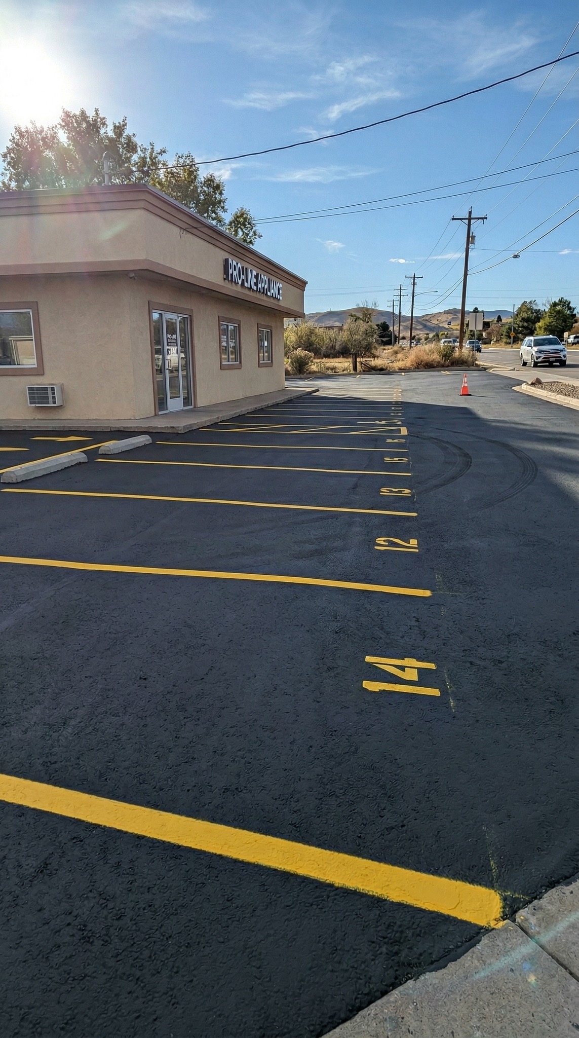 Parking lot after D&M Paving repaved and striped with numbered yellow spaces