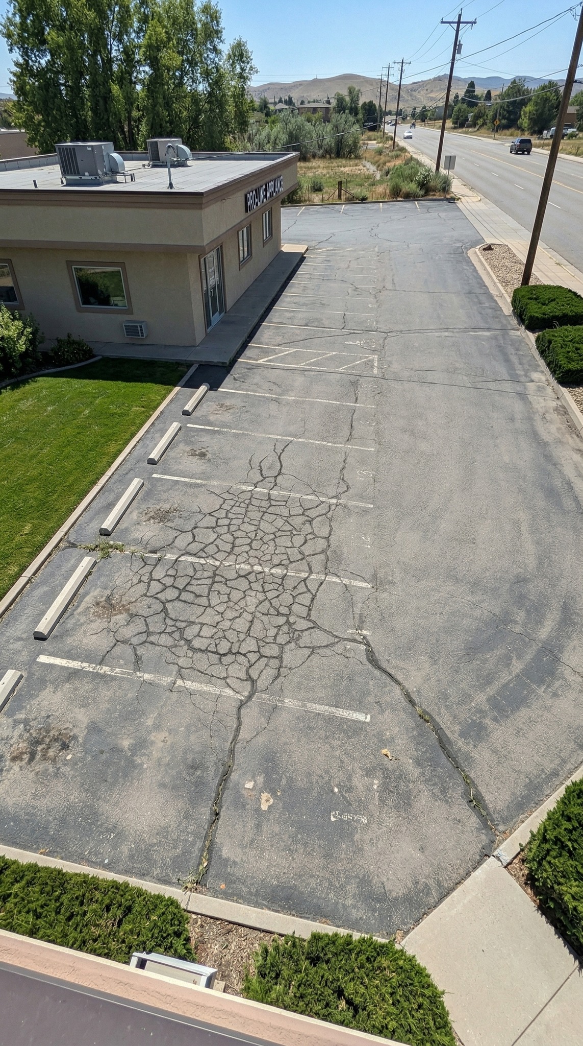 Commercial parking lot with severe alligator cracking before D&M Paving