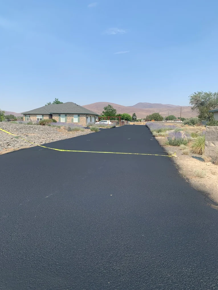 Fresh asphalt road stretching across the Colorado high desert