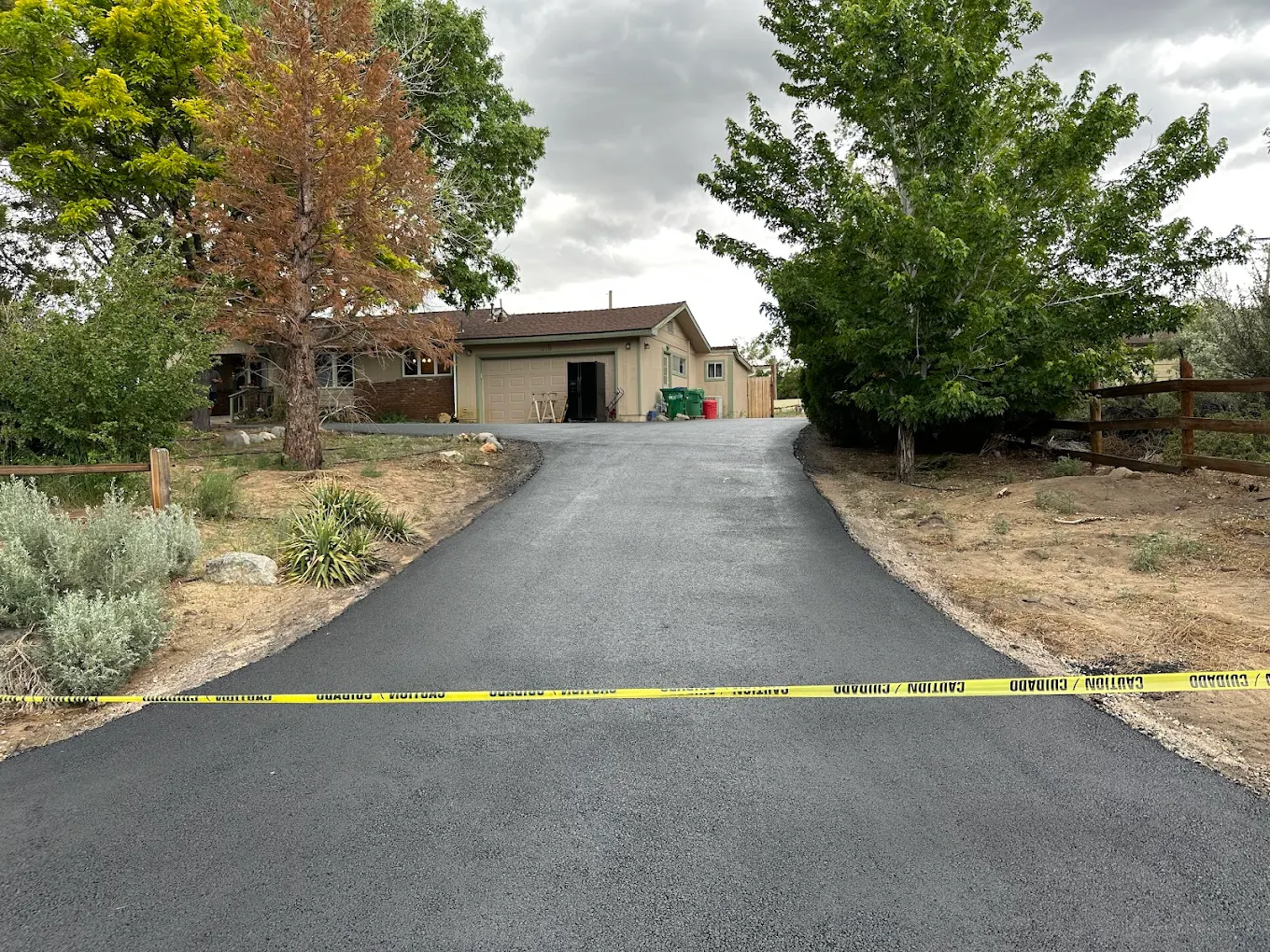 Freshly paved driveway sealed off with caution tape during cure time