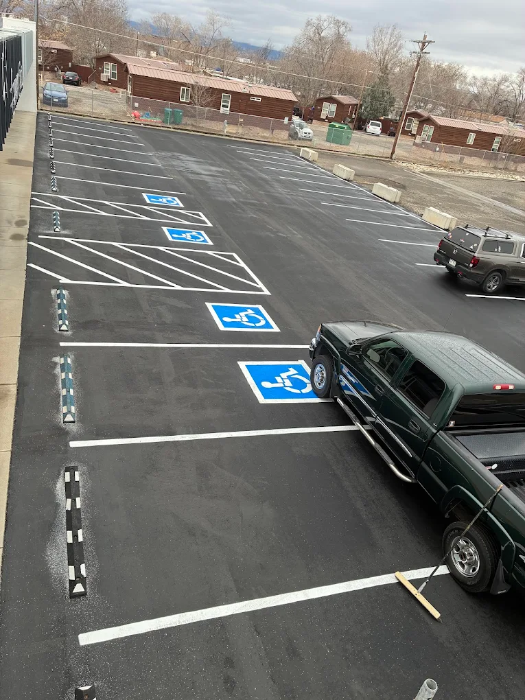 Accessible parking spaces freshly striped in a paved lot